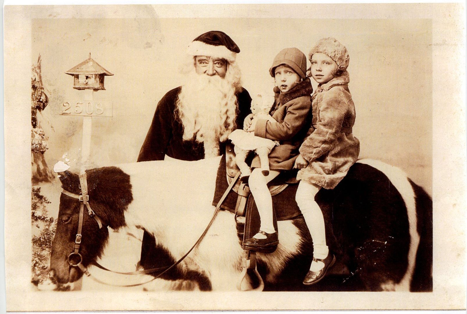 Kids pose on a horse with Santa at Famous-Barr in 1933